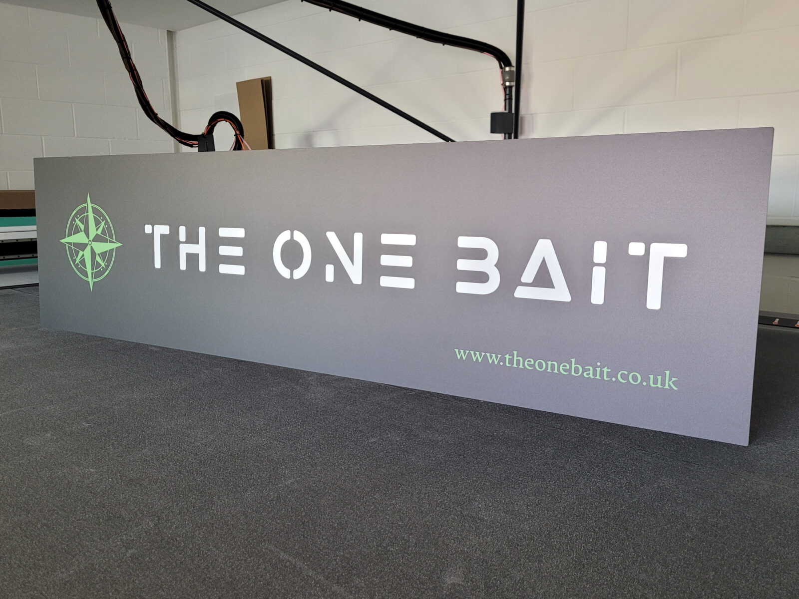 An ACM panel having just been cut to shape, to be used for business entrance signage