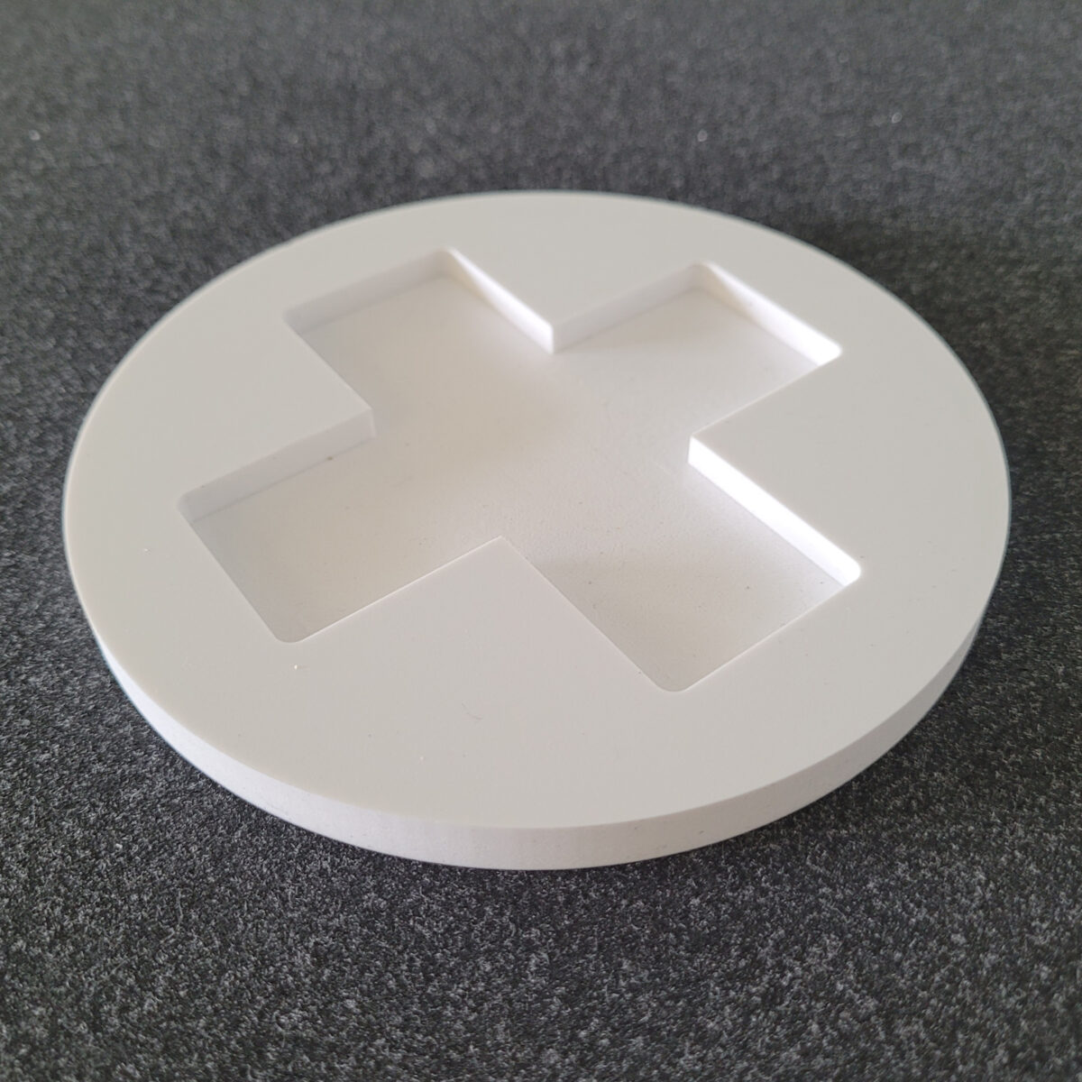 A 10mm foamex panel, routed into a circle with the addition of a 5mm deep washed out cross design