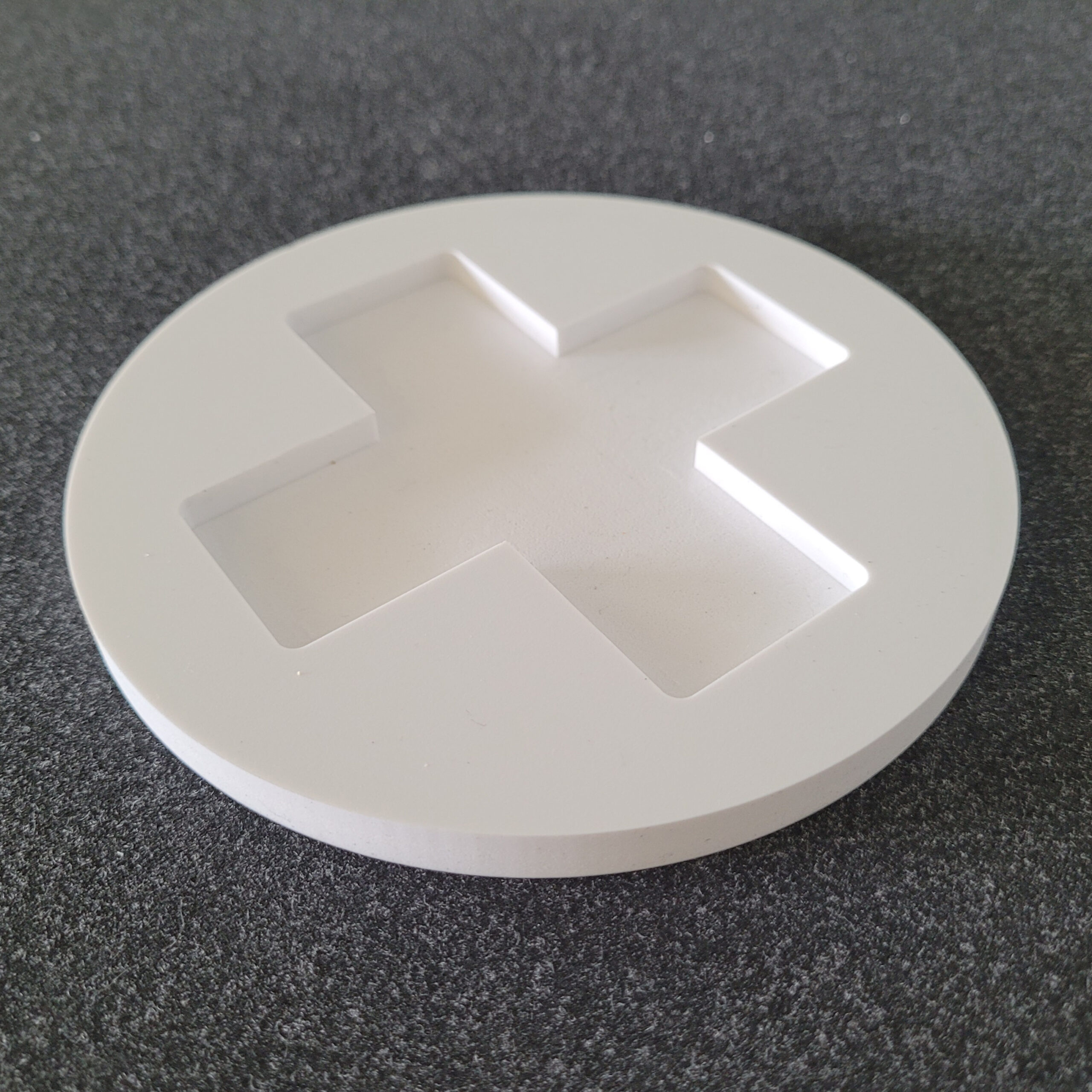 A 10mm foamex panel, routed into a circle with the addition of a 5mm deep washed out cross design