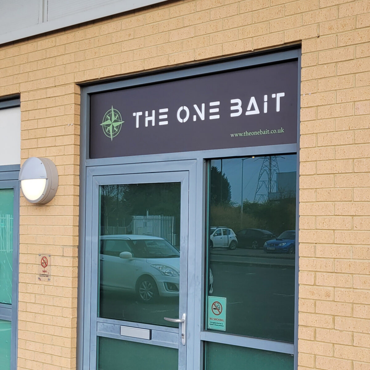 A 3mm ACM panel, printed with a business logo, shown fitted above the office door