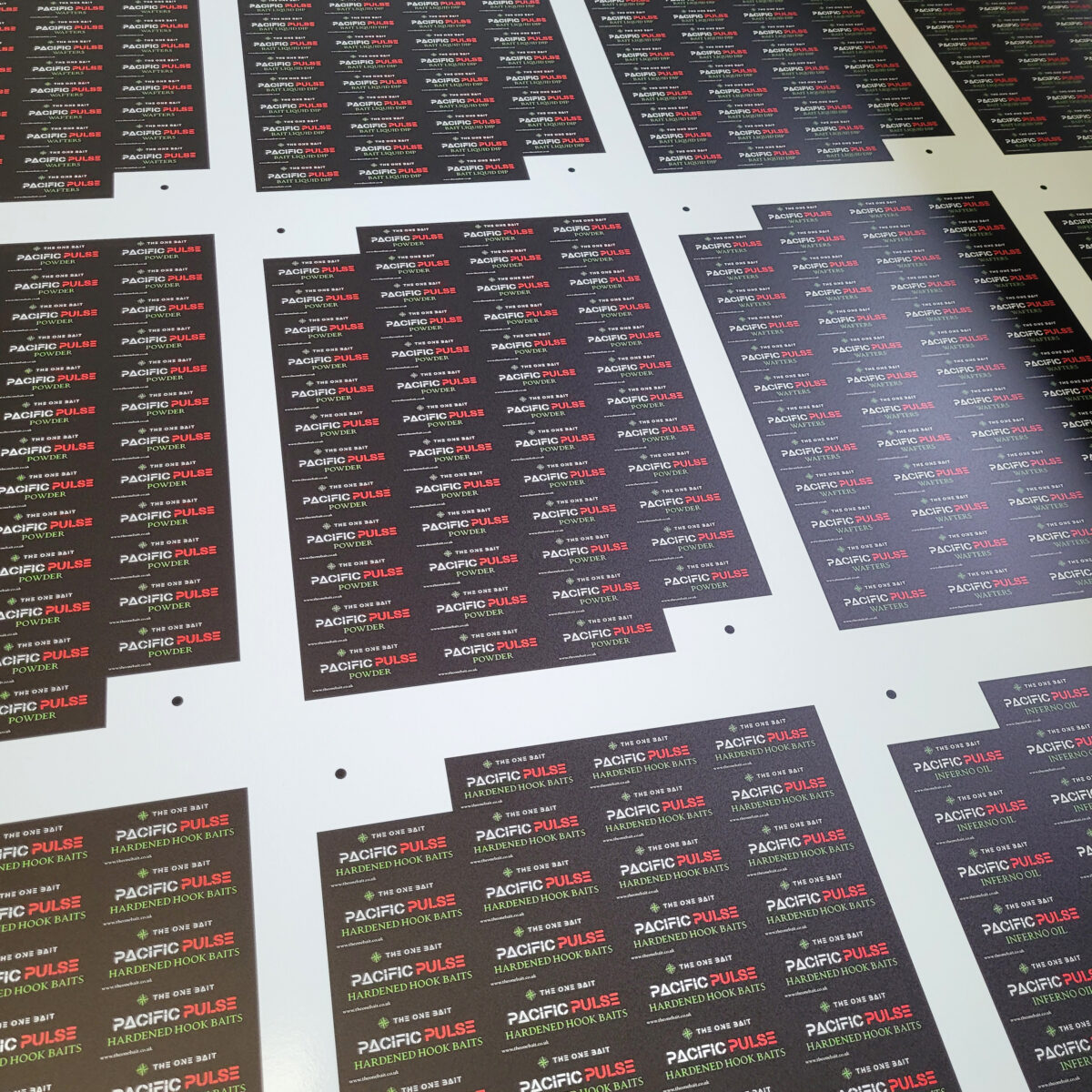 Roll printed labels about to be kiss cut and trimmed to sheets
